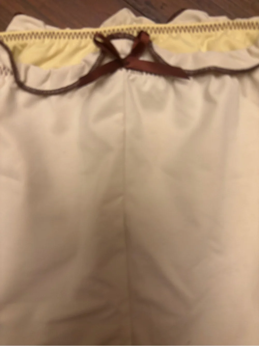Frankie’s bikinis x Gigi HADID yellow swim shorts with brown trim